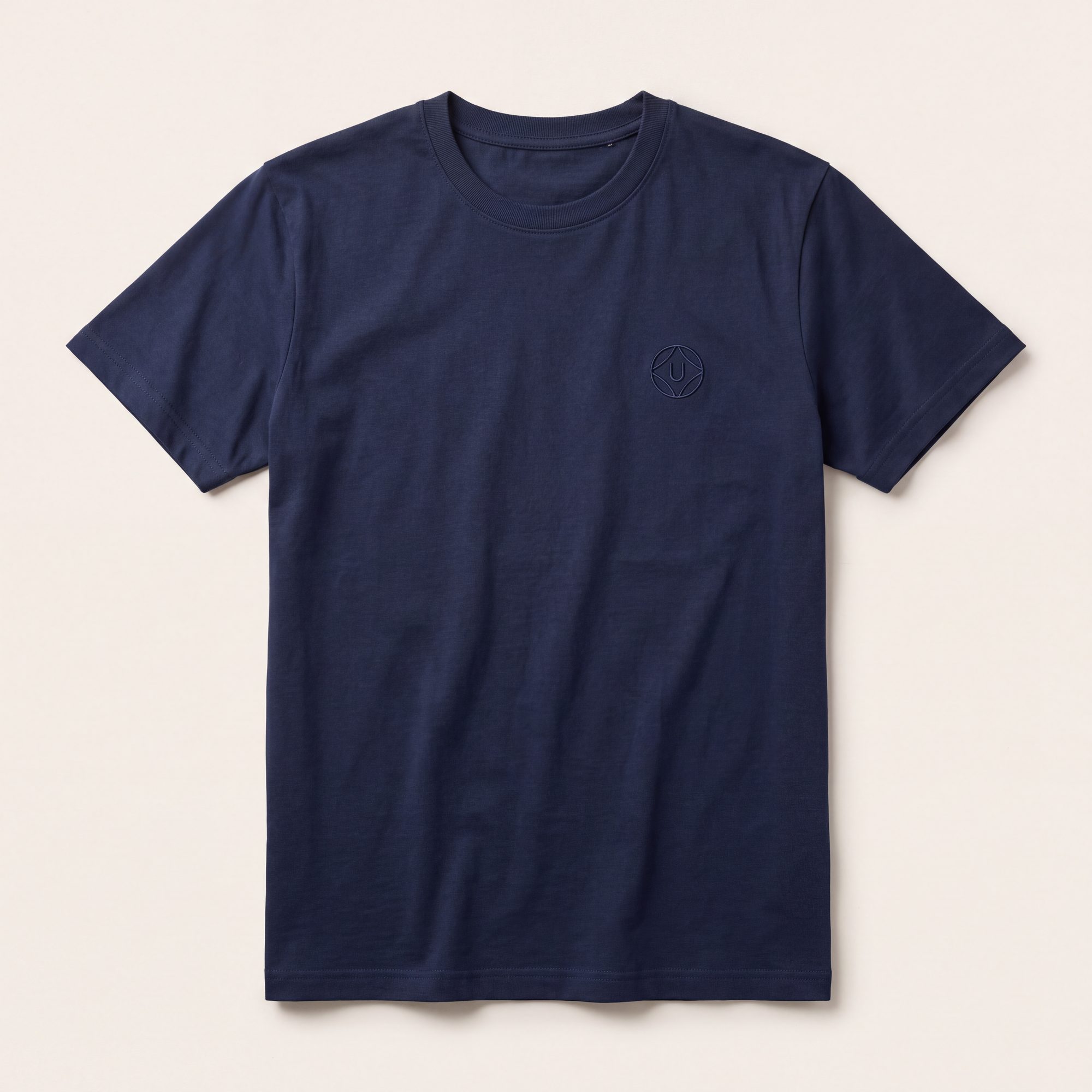 Navy t-shirt with tonal embroidered emblem, laid flat